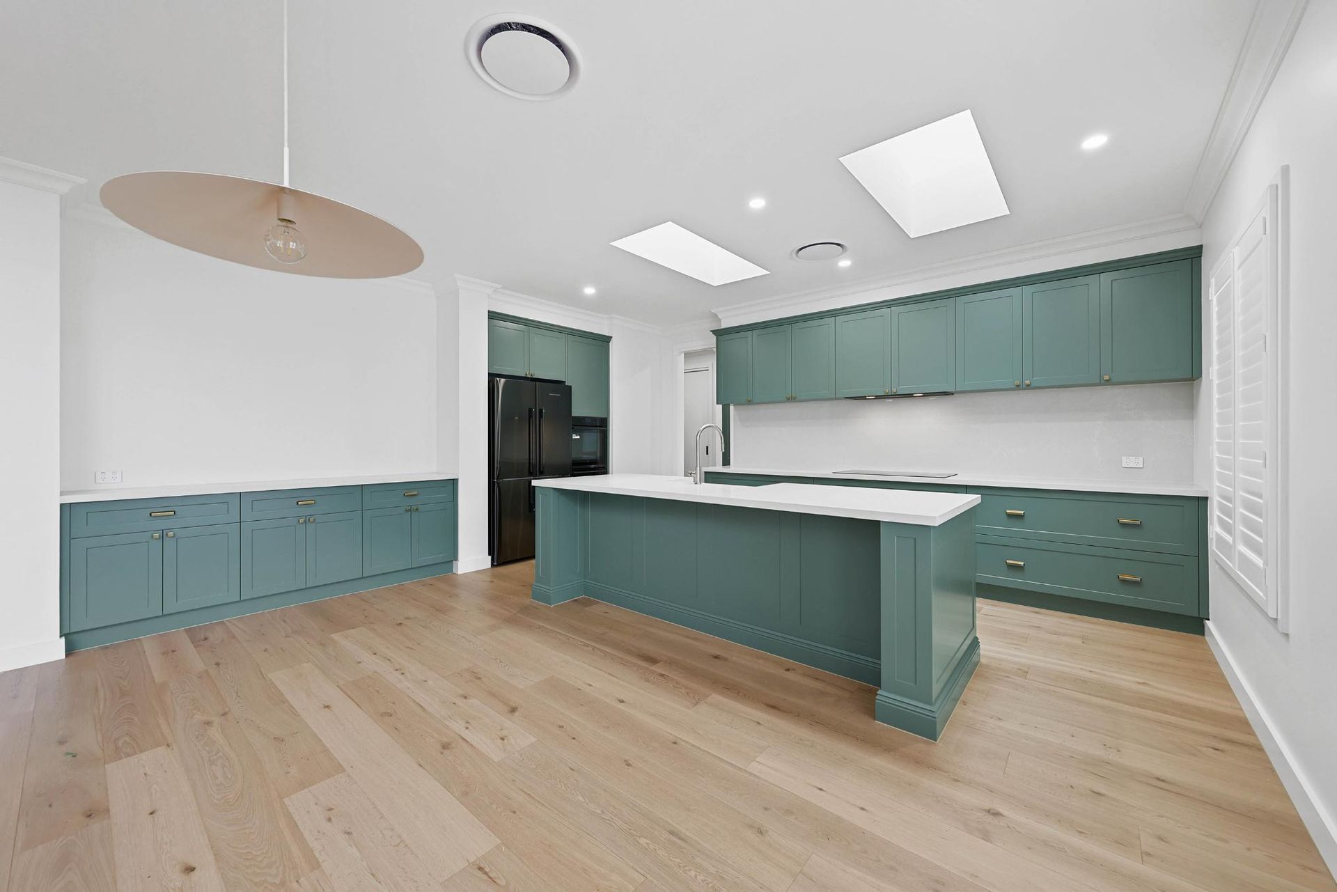 Spacious Kitchen with Teal Cabinets, White Countertops, Wooden Floors, and An Island — Above & Beyond Interiors Custom Joinery in Appin, NSW