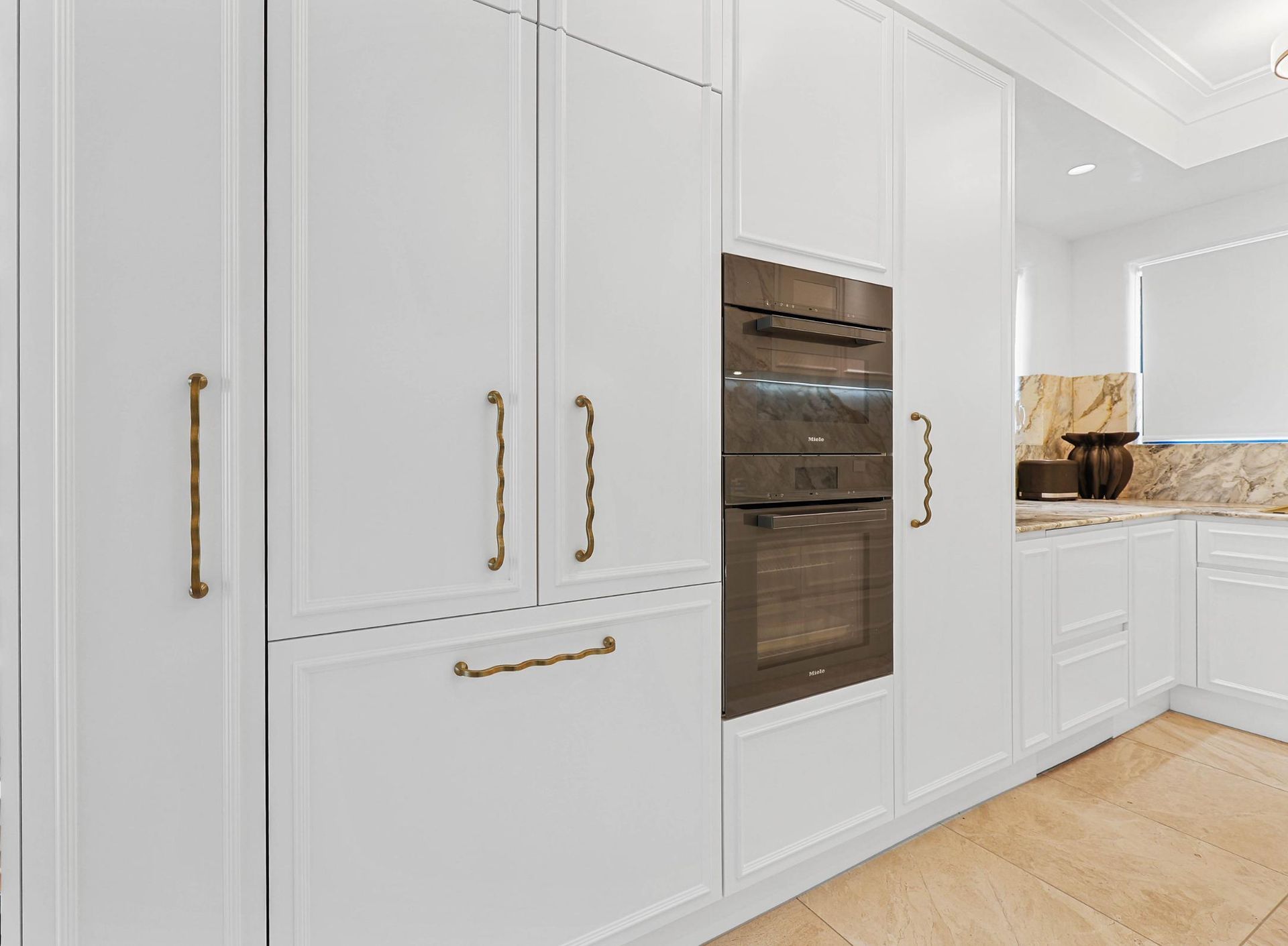 White Kitchen Cabinets with Brass Handles; Built-In Oven — Above & Beyond Interiors Custom Joinery in Double Bay, NSW