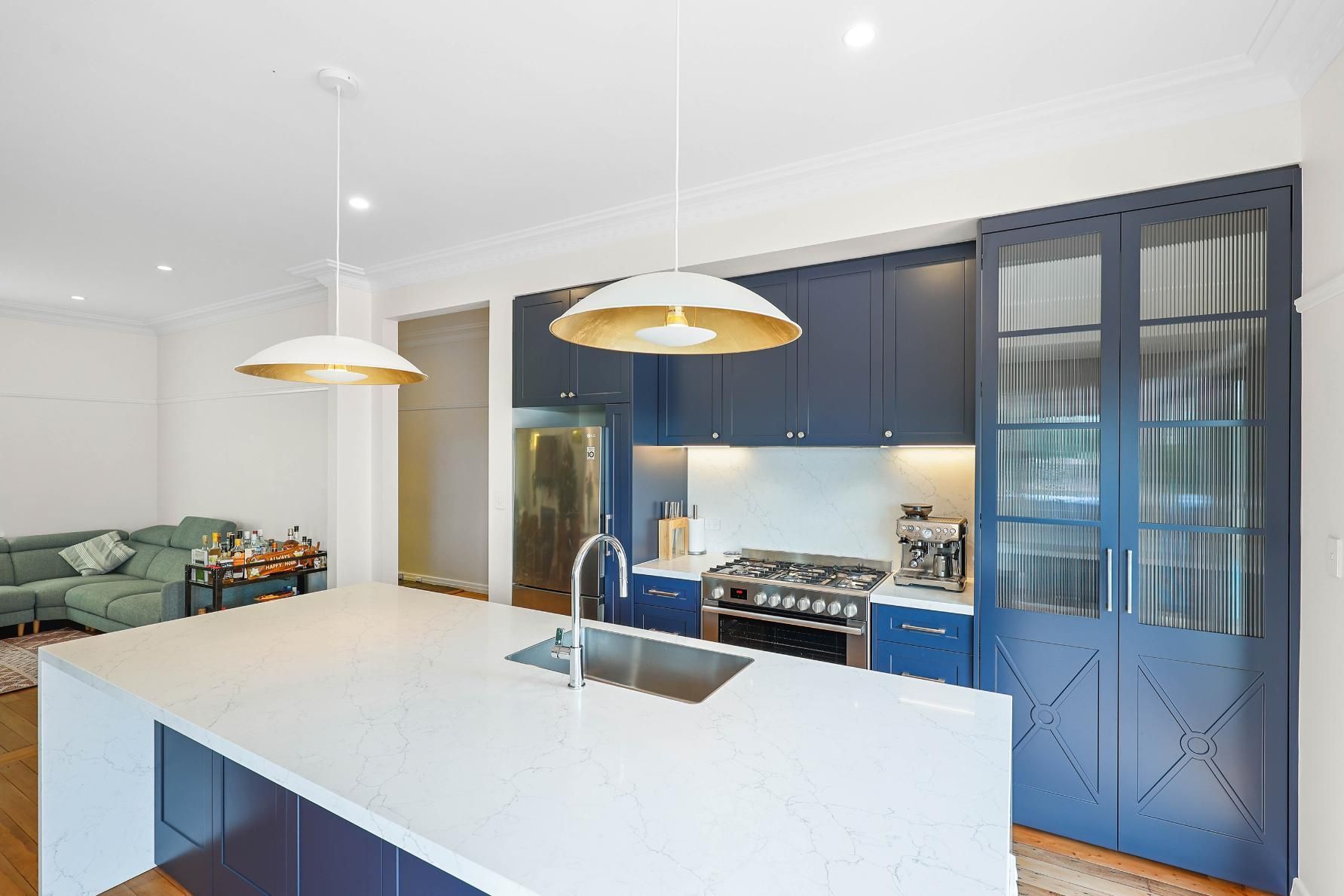 Modern Kitchen with Blue Cabinets, White Countertops, and Gold Pendant Lights — Above & Beyond Interiors Custom Joinery in Lilyfield, NSW
