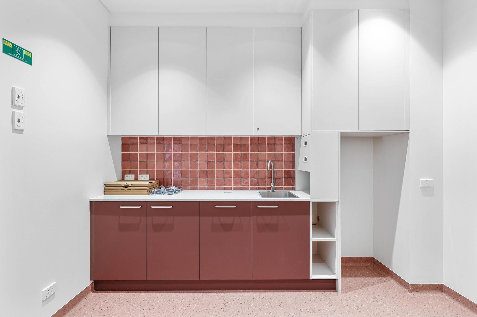 Kitchen with Burgundy Cabinets, White Uppers, Red Tile Backsplash, and An Open Cubby — Above & Beyond Interiors Custom Joinery in Medical Centre, NSW