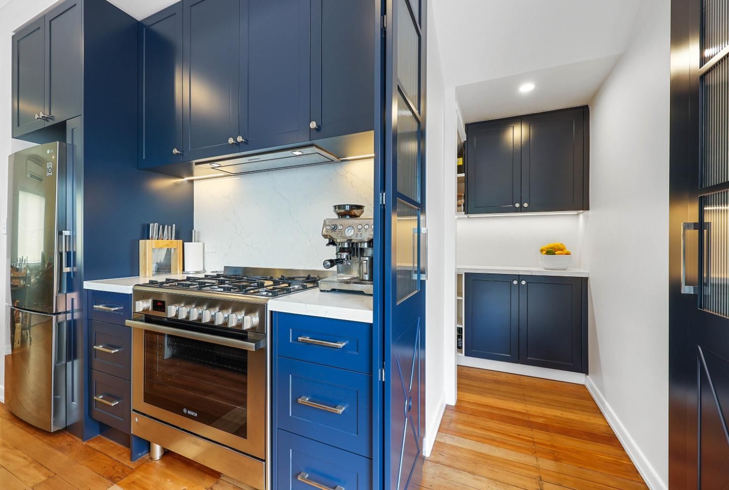 Blue Kitchen with Stainless Steel Appliances and Wood Floors — Above & Beyond Interiors Custom Joinery in Lilyfield, NSW