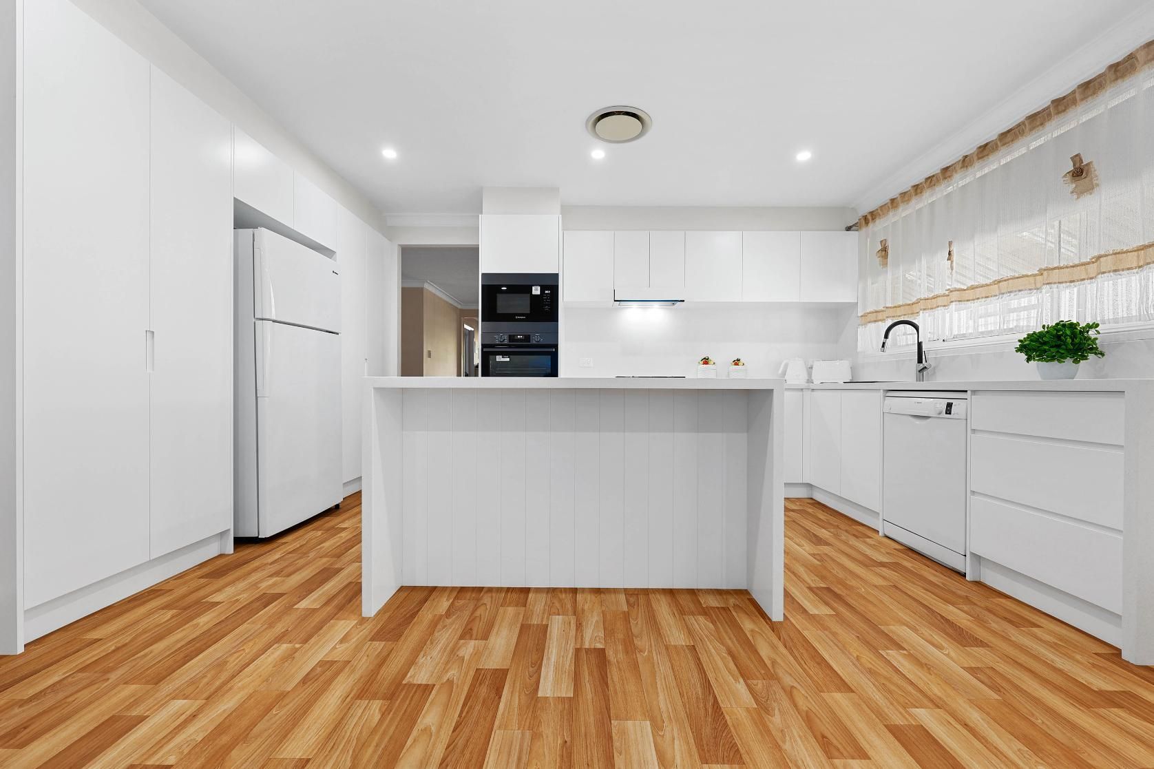 White Modern Kitchen with Wooden Floors; Features Cabinets, Island, Appliances — Above & Beyond Interiors Custom Joinery in Narellan Vale, NSW