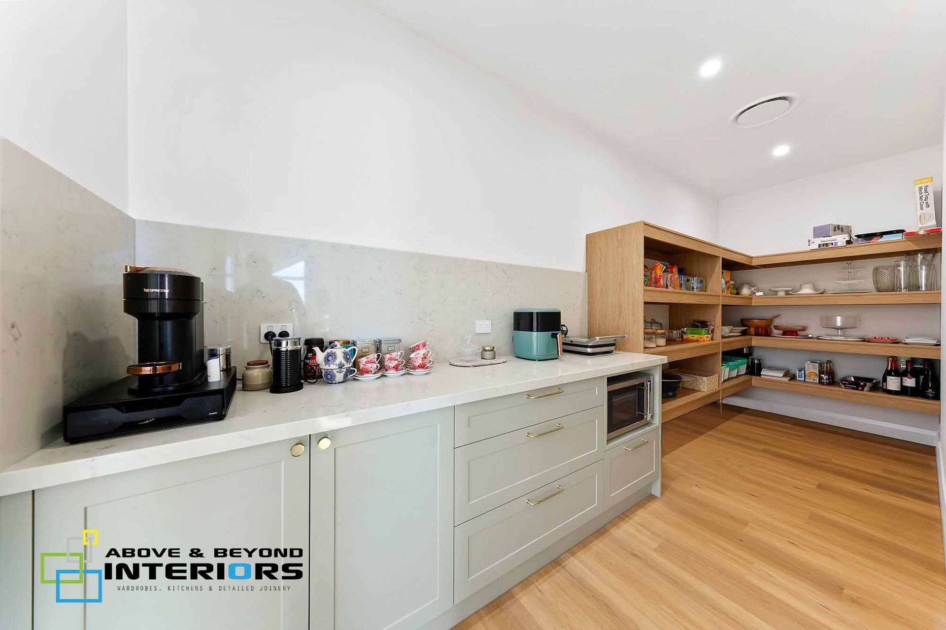 Modern Kitchen with White Cabinets and  Wood Countertops — Above & Beyond Interiors in Smeaton Grange, NSW