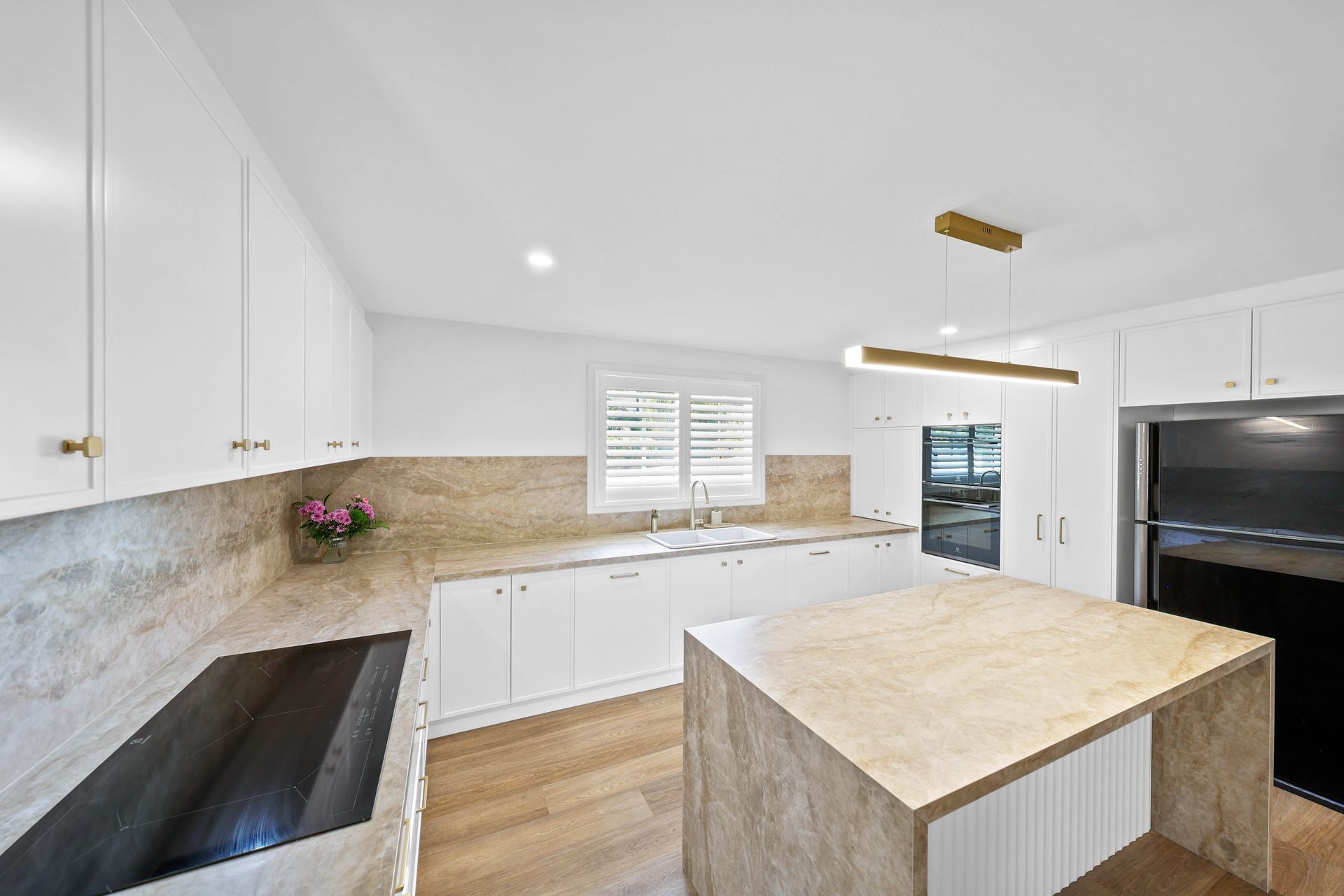 Bright White Kitchen With Stone Countertops — Above & Beyond Interiors in Smeaton Grange, NSW