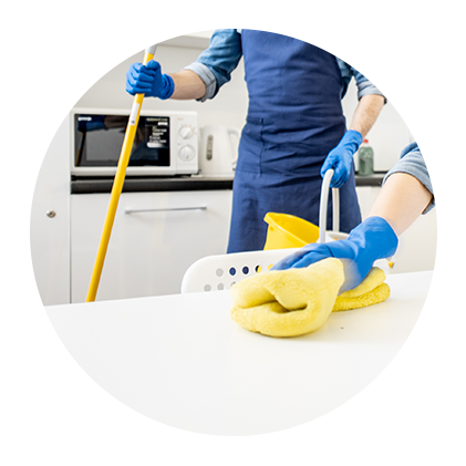 A person is cleaning a table with a mop and a towel.
