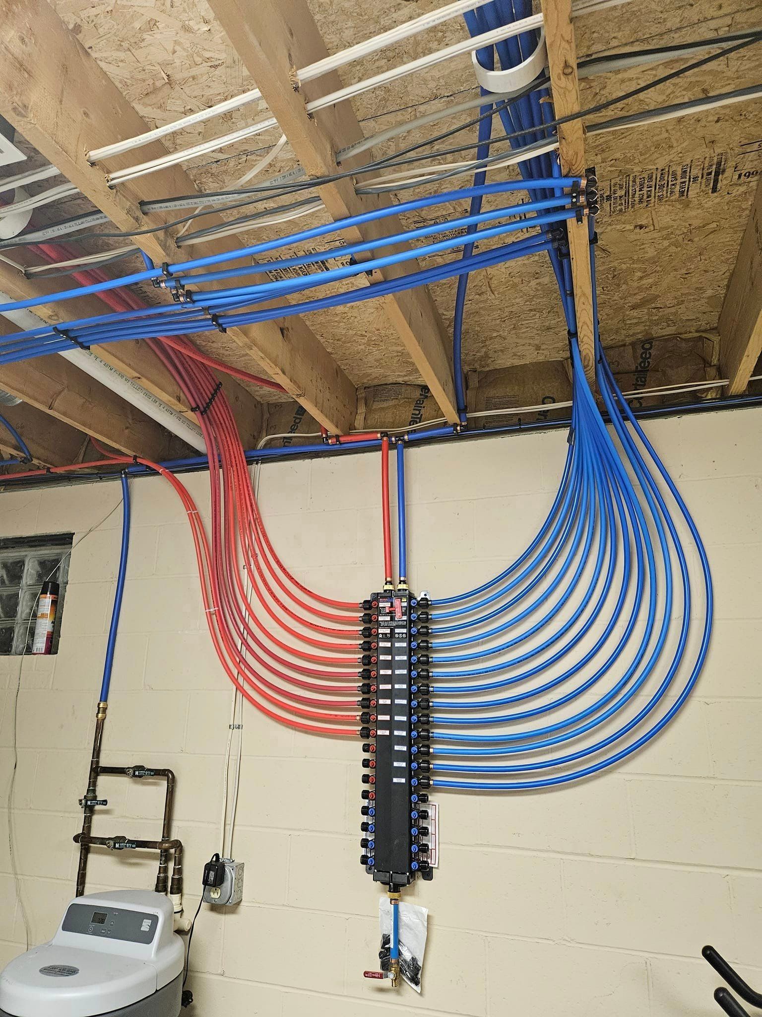 A bunch of pipes are hanging from the ceiling in a room.