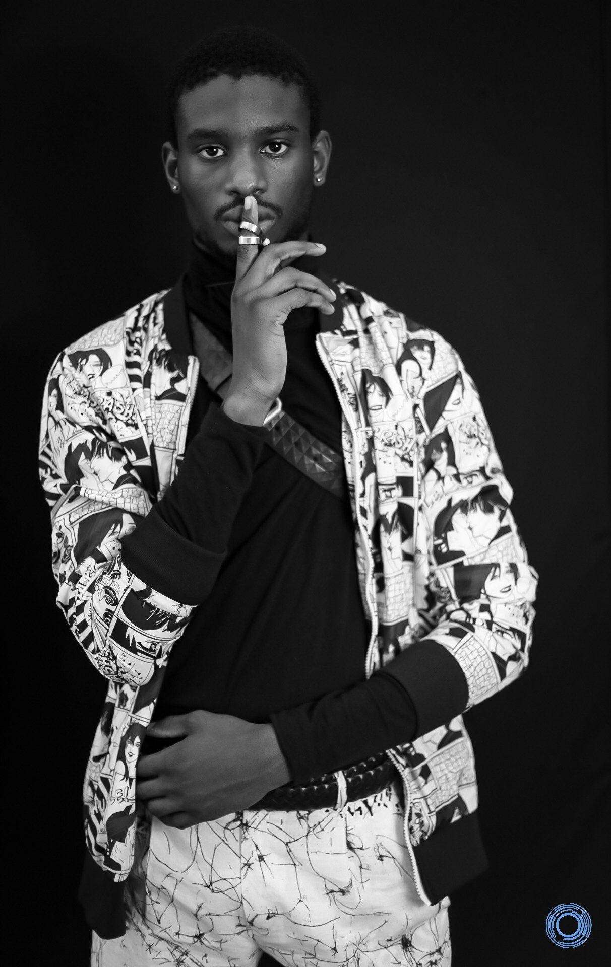 A black and white photo of a man wearing a jacket that says versace
