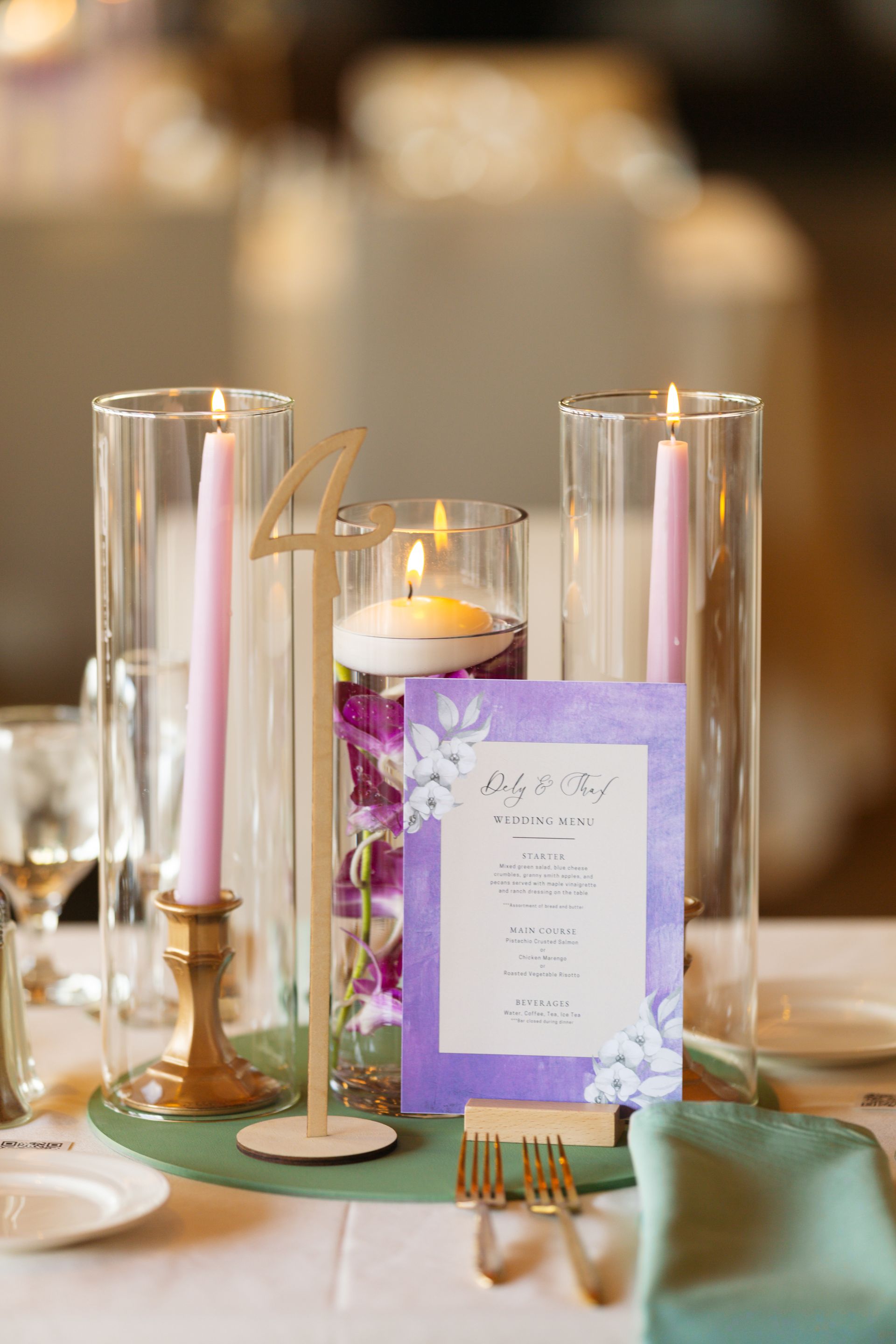 A table with candles and a menu on it