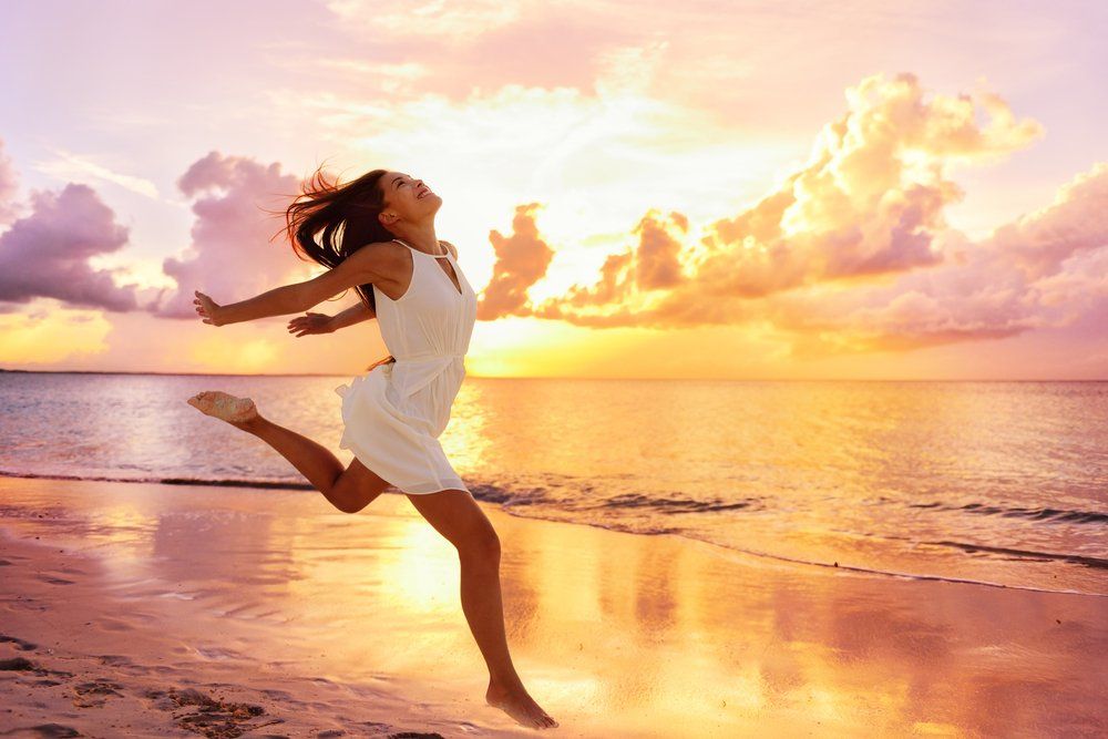 Happy Careless Woman Feeling Blissful Jumping of Joy — Colonic Healthcare in Rosslea, QLD