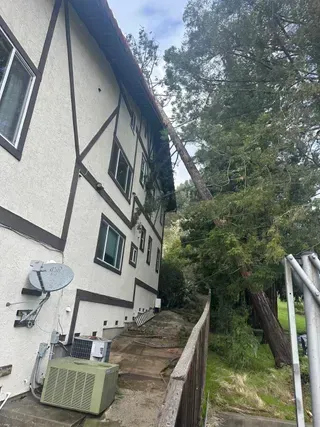A large white building with a satellite dish on the side of it.