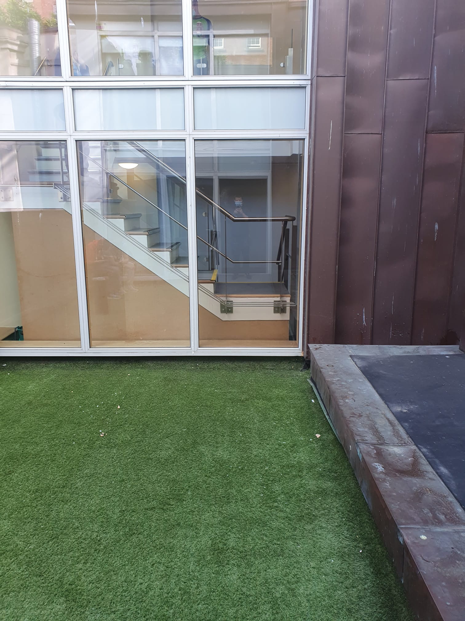 A building with stairs leading up to it and a large window.