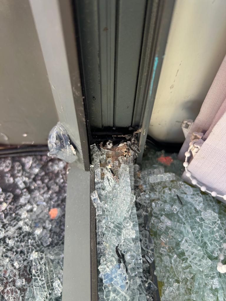 A window with a lot of broken glass on it.