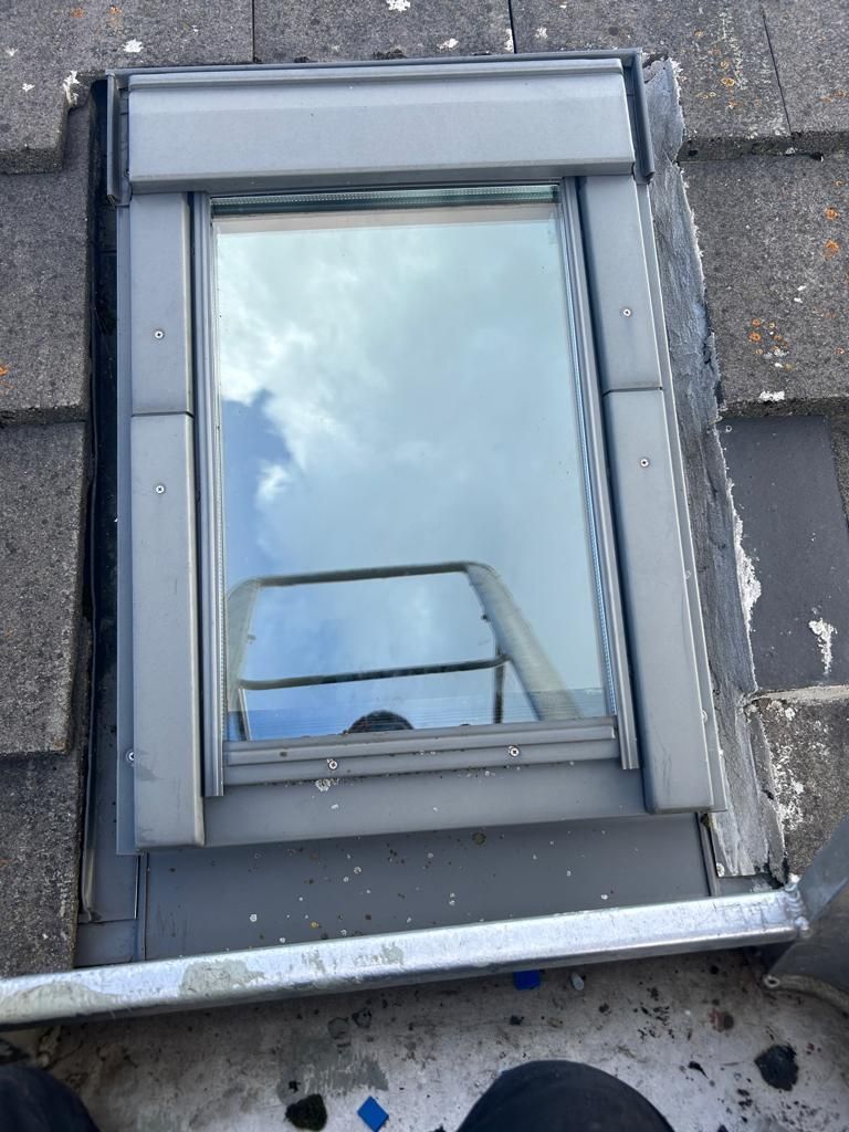 A skylight is sitting on top of a roof.