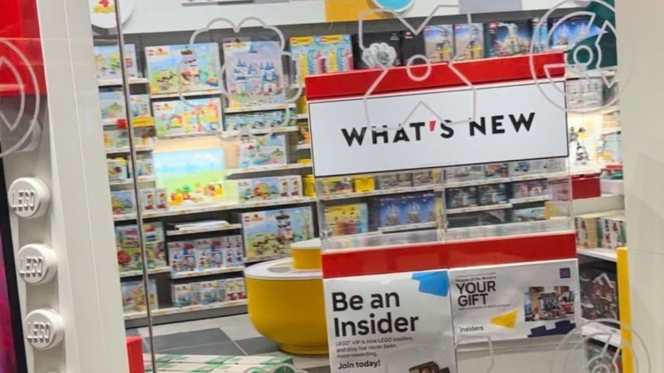 A toy store with a sign that says `` what 's new '' and a sign that says `` be an insider ''.