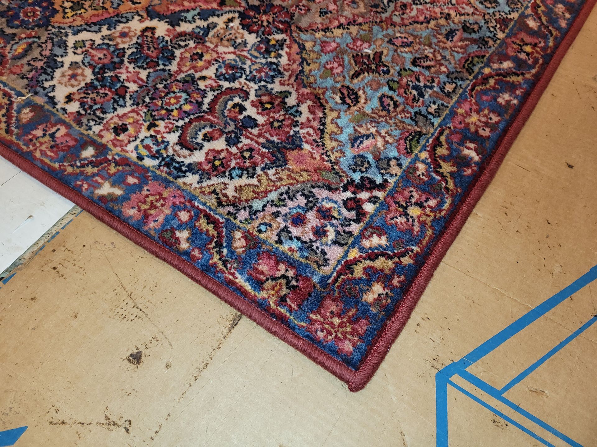 A Rug is Rolled Up on a Wooden Floor