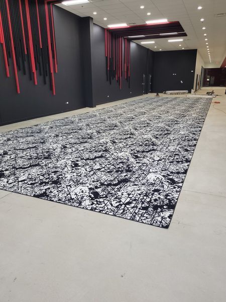 A Large Room With a Large Rug on the Floor