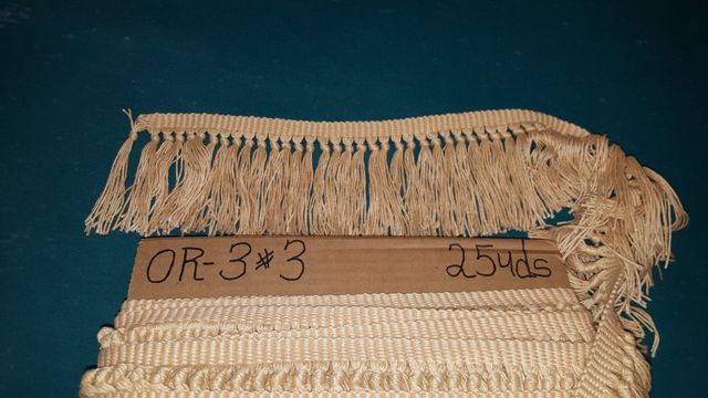 A Piece of Rope With Fringe is Sitting on Top of a Cardboard Box