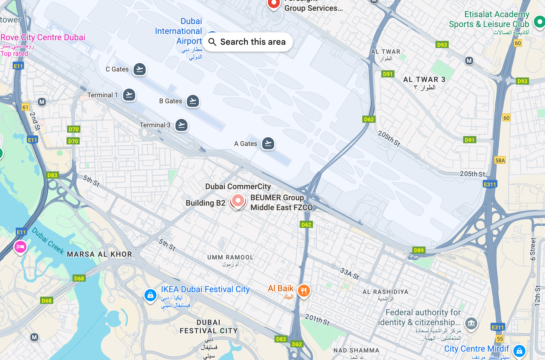 Map of Dubai with Dubai International Airport in the center, showing roads and buildings.