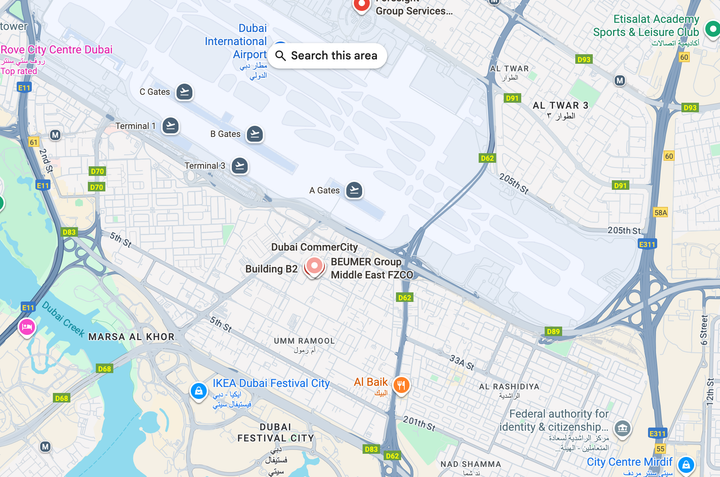 Map of Dubai with Dubai International Airport in the center, showing roads and buildings.