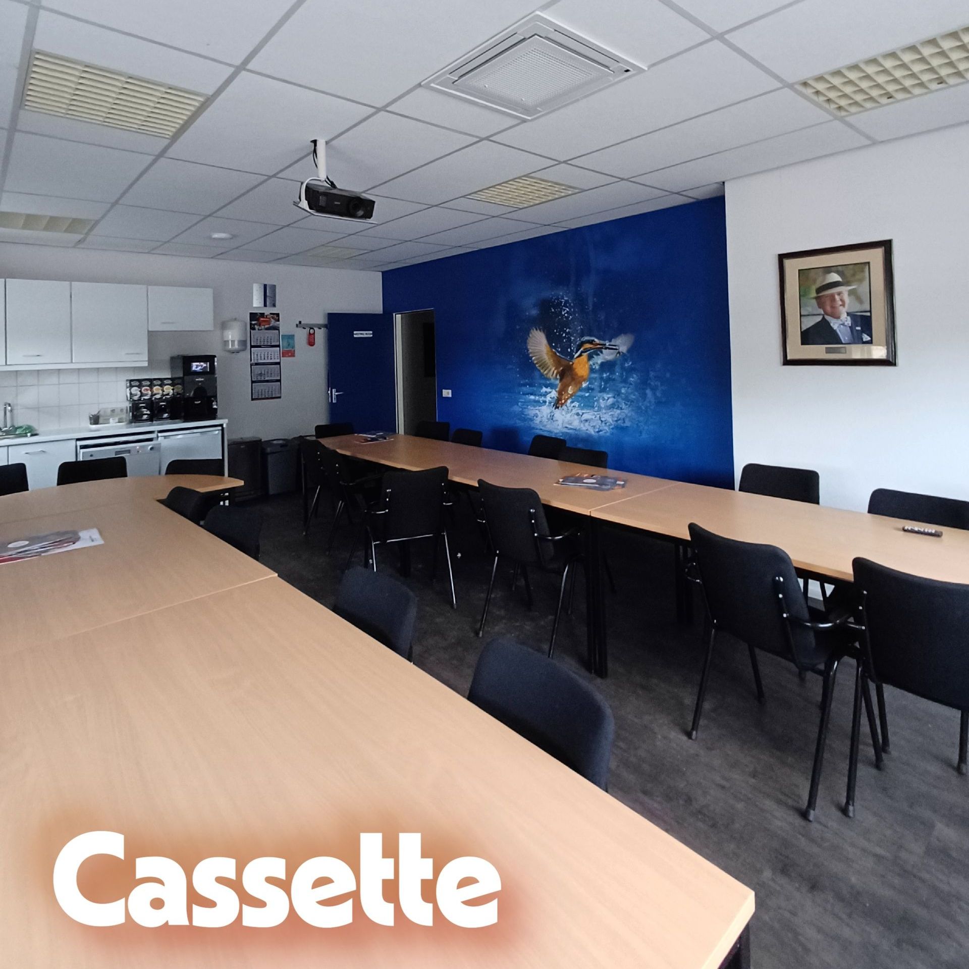 Kantoorruimte met systeemplafond waarin een cassette airco is geïnstalleerd, zichtbaar boven het bureau met computer en documenten.