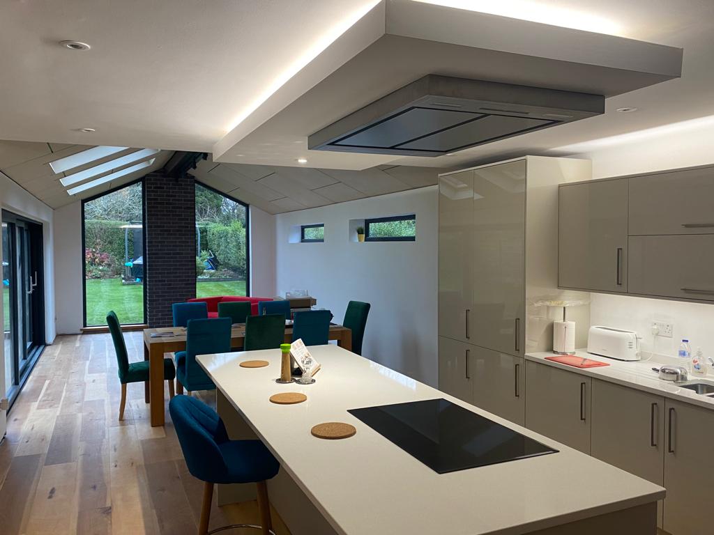 A kitchen with a large island and a stove top oven.