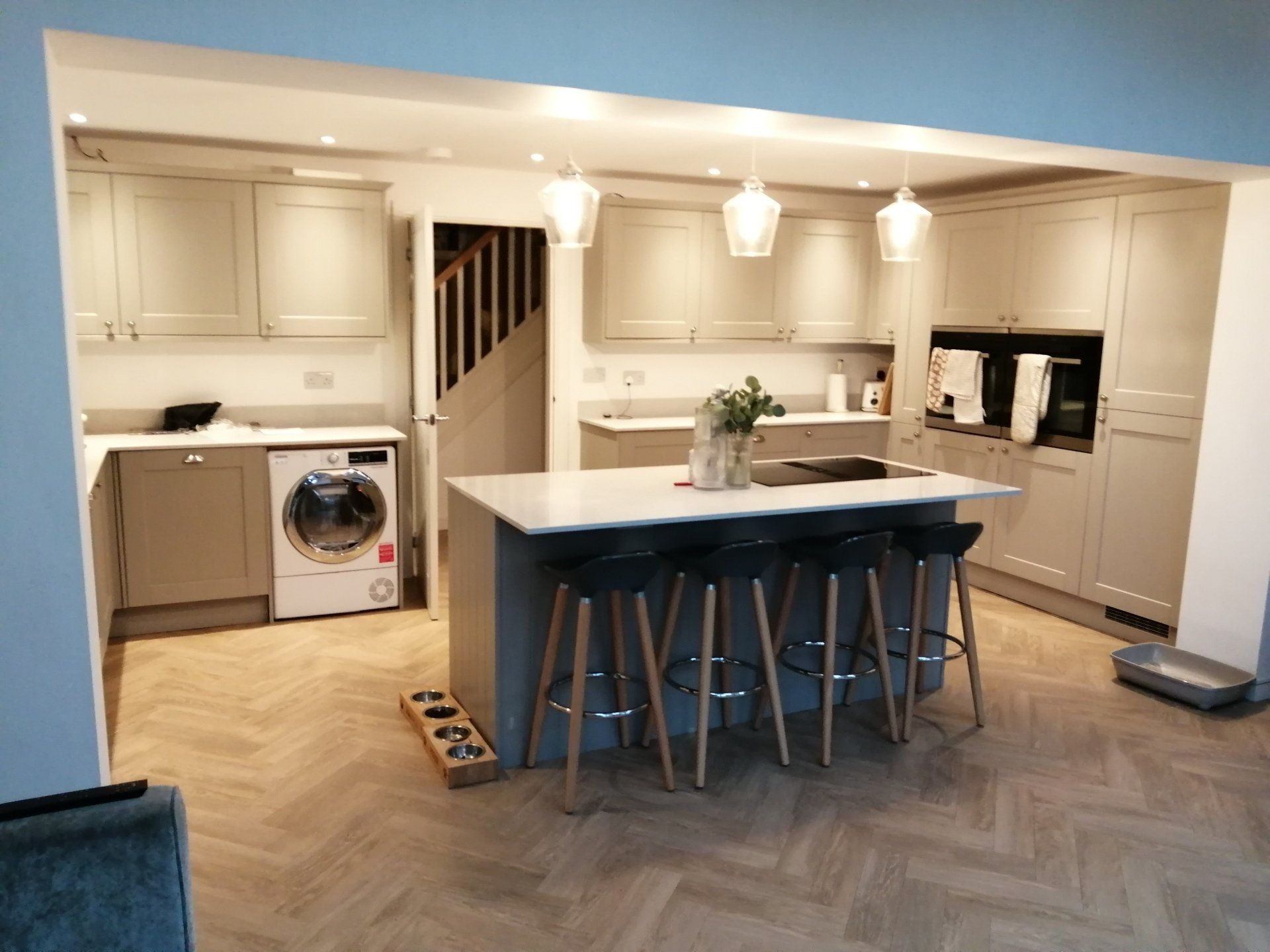 A kitchen with a large island and stools