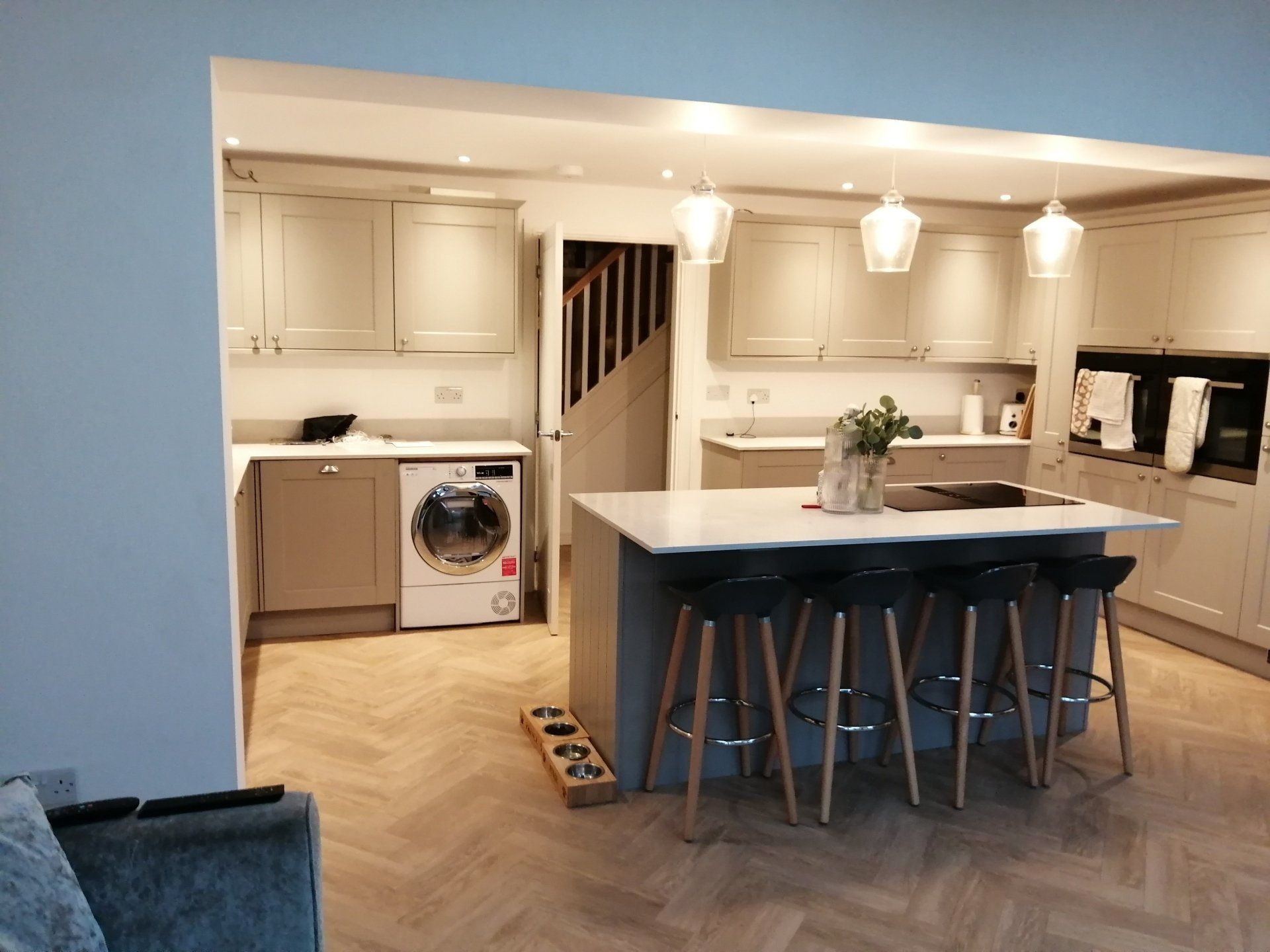 A kitchen with a large island and stools