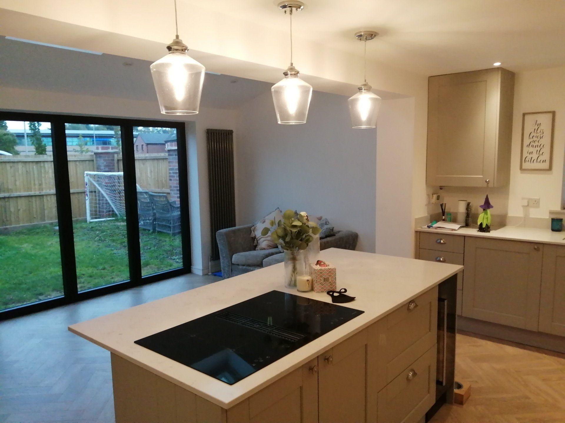 A kitchen with a large island and a stove top oven.