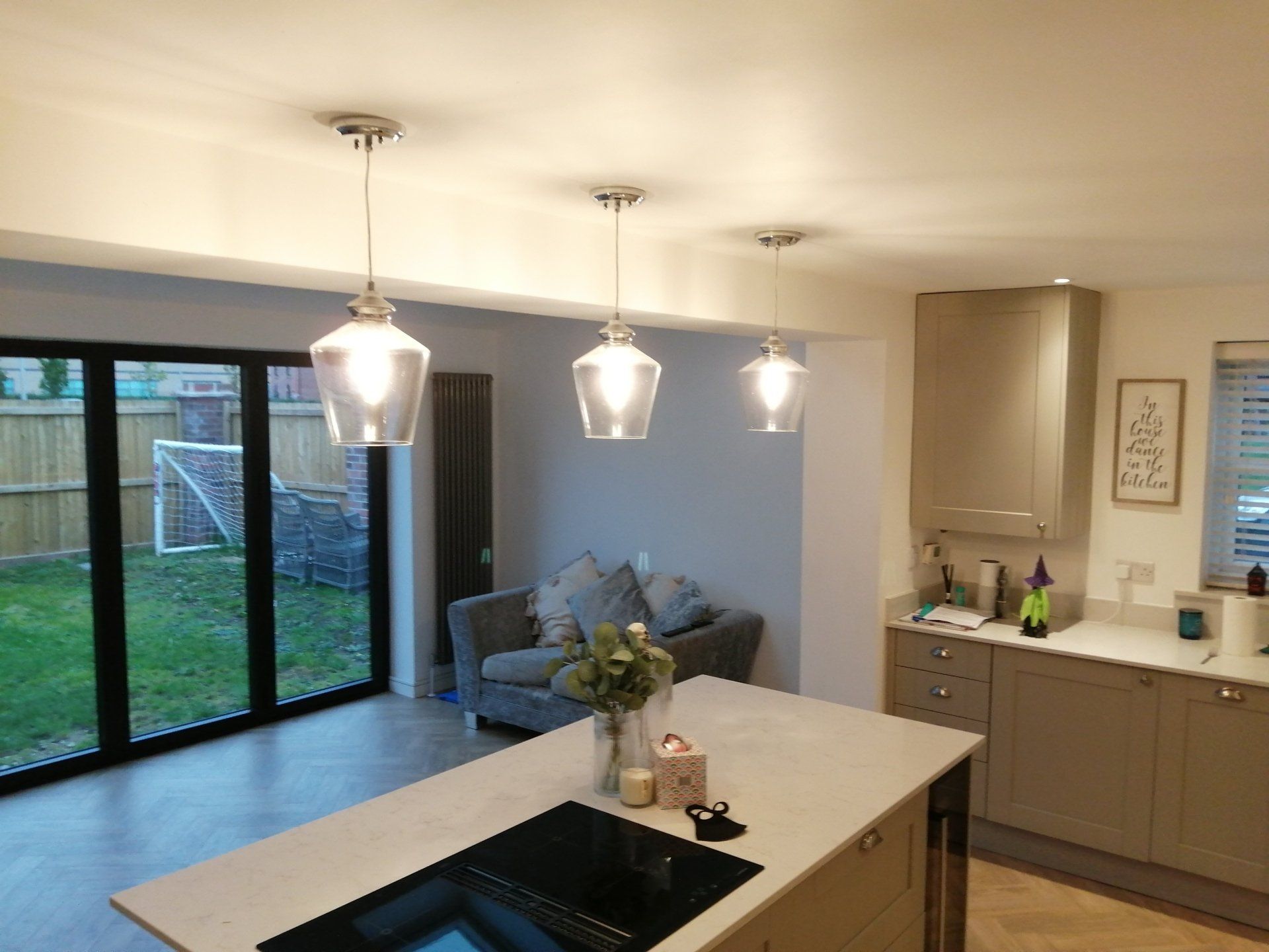 A kitchen with a large island and a stove top oven.