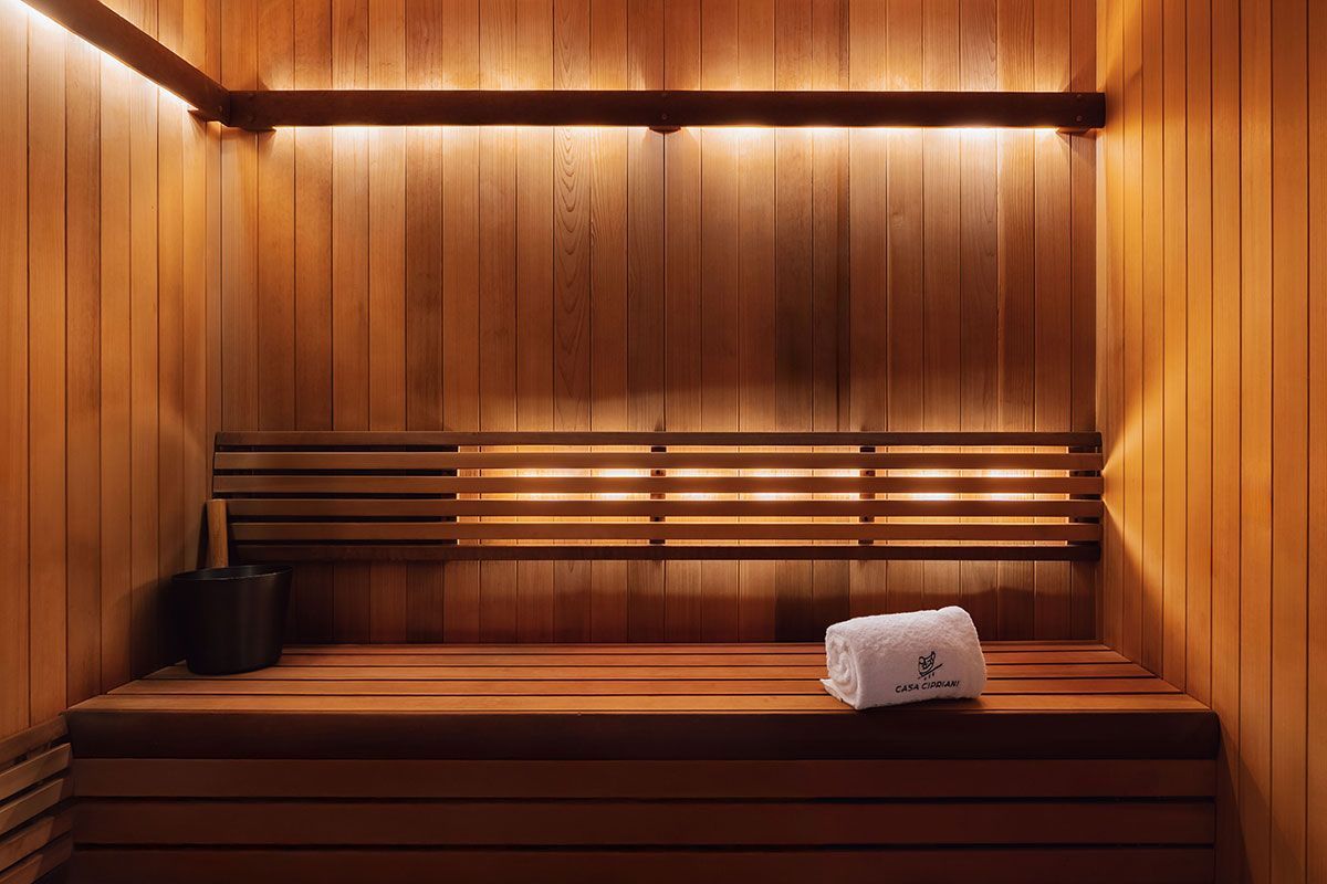 A wooden sauna with a towel on the bench.