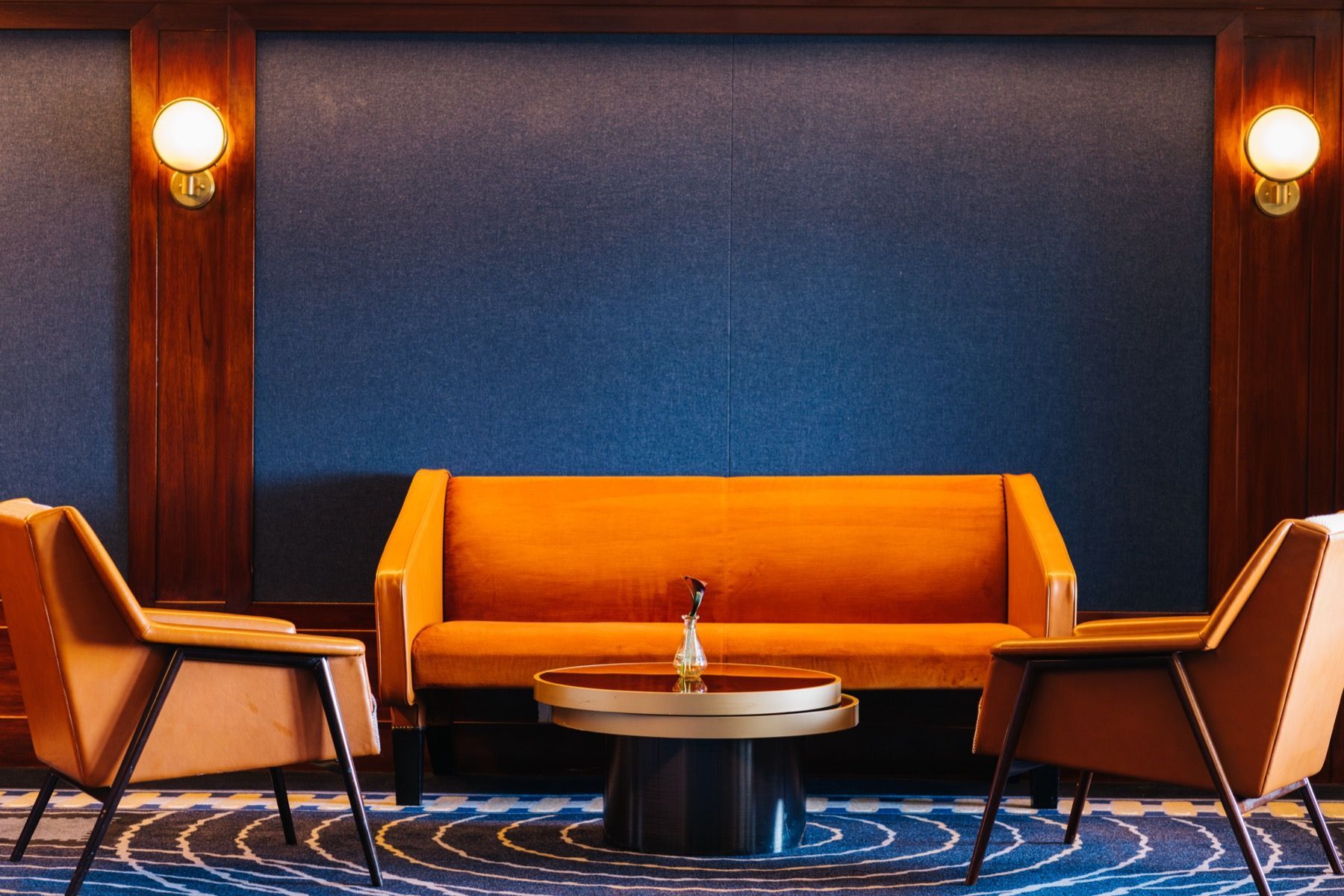 A living room with a couch , chairs , and a table.