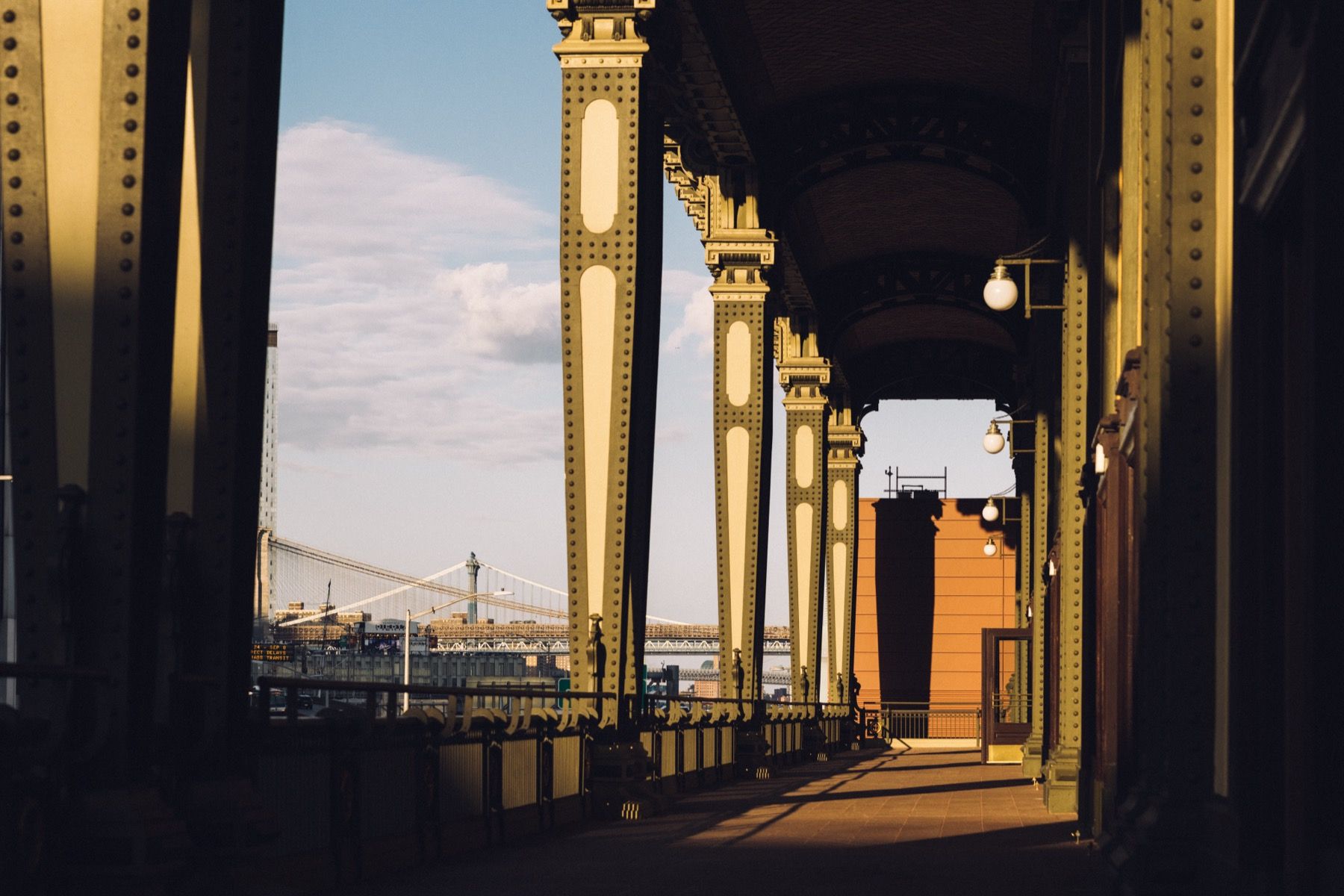 A bridge with a lot of columns and a bridge in the background