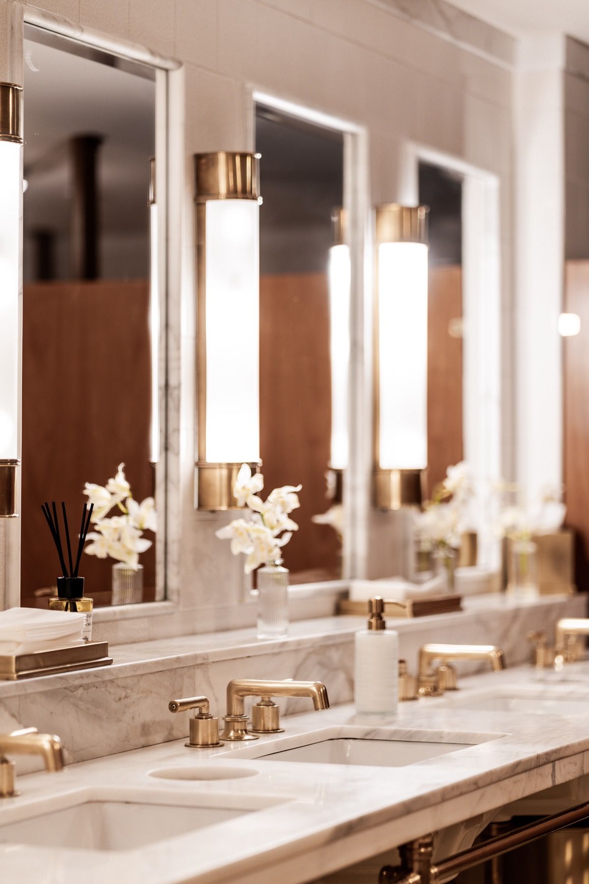 A bathroom with a row of sinks and mirrors.