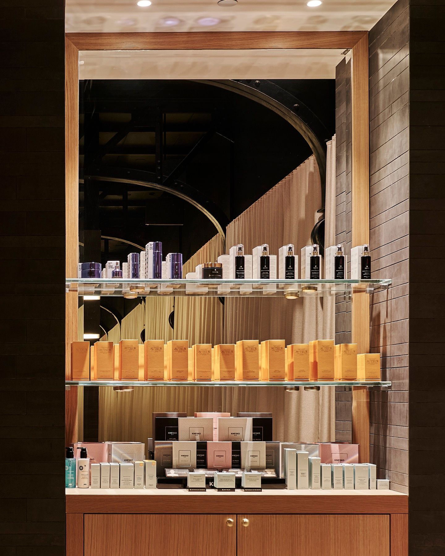 A display of beauty products in a store with a mirror