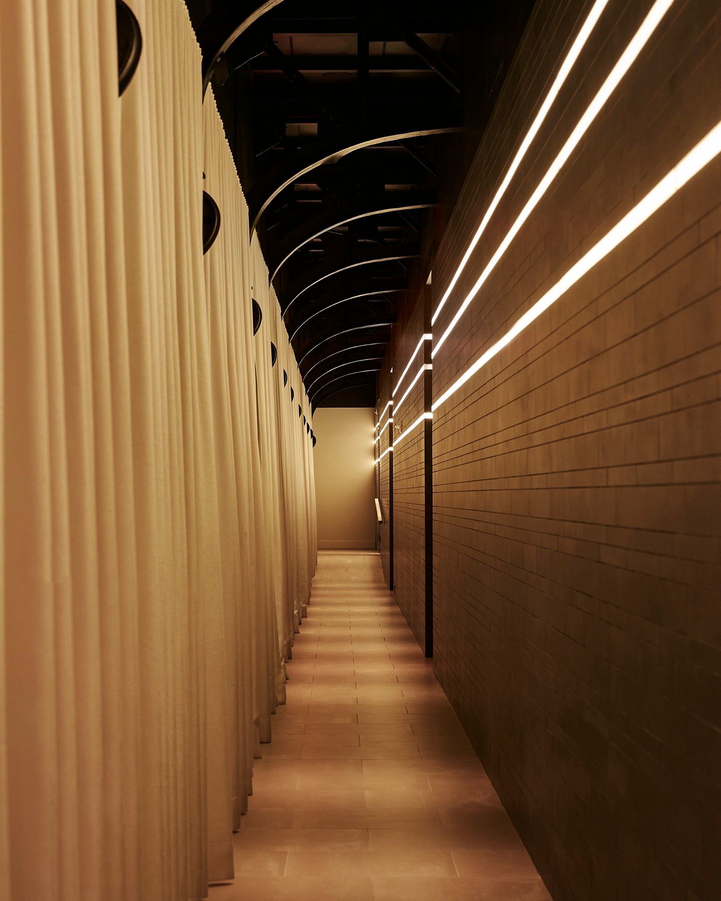 A long hallway with a lot of lights on the walls
