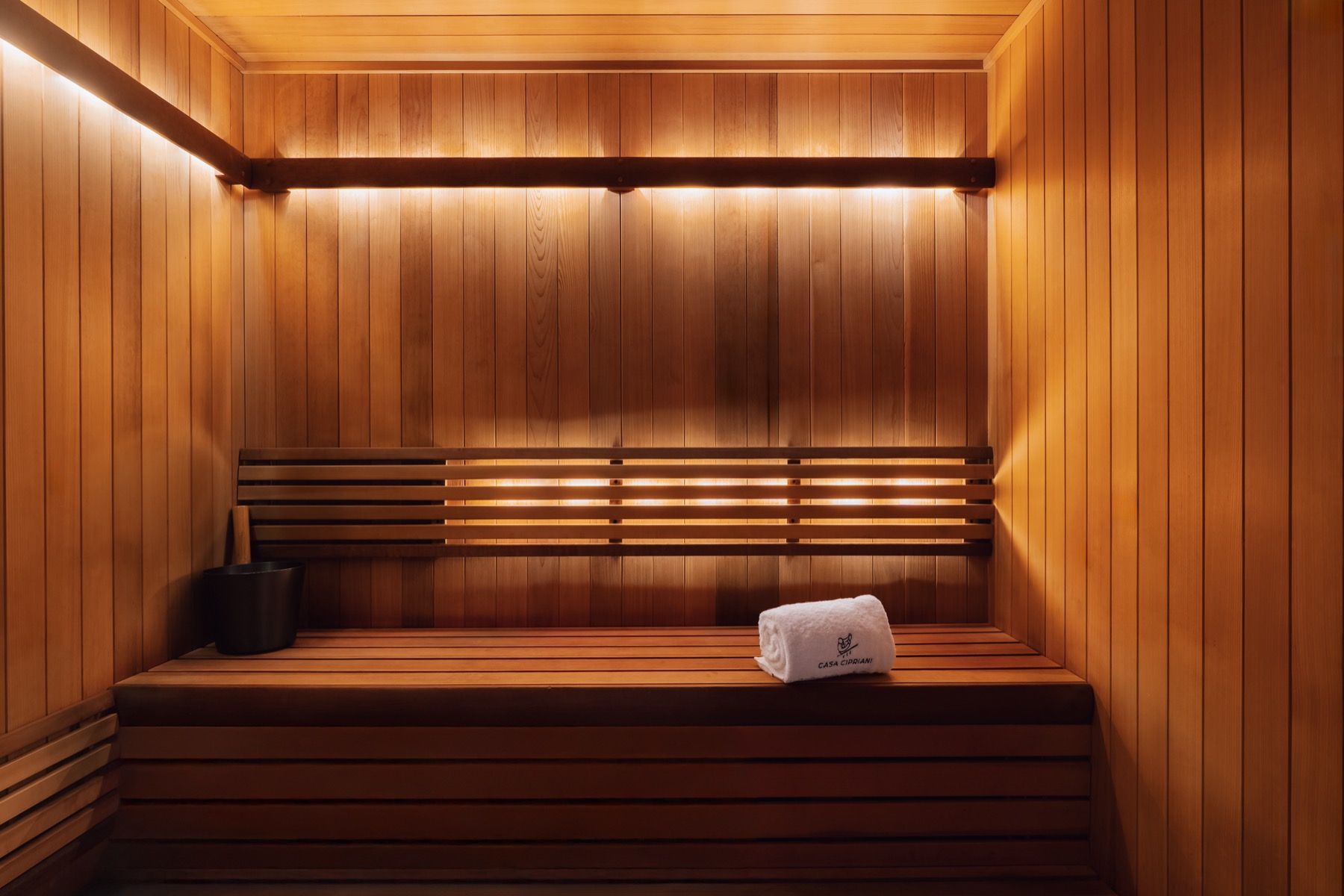 A wooden sauna with a towel on the bench.