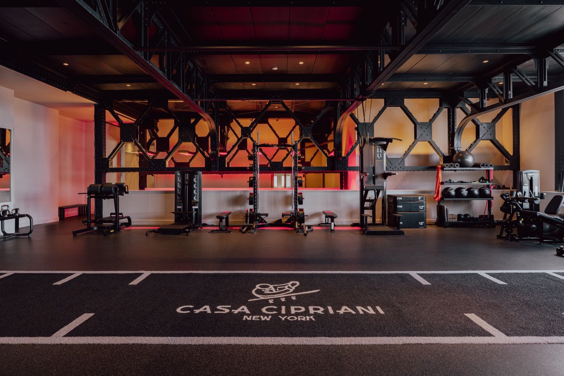 A gym with a carpeted floor and a sign that says casa cipriani on it.