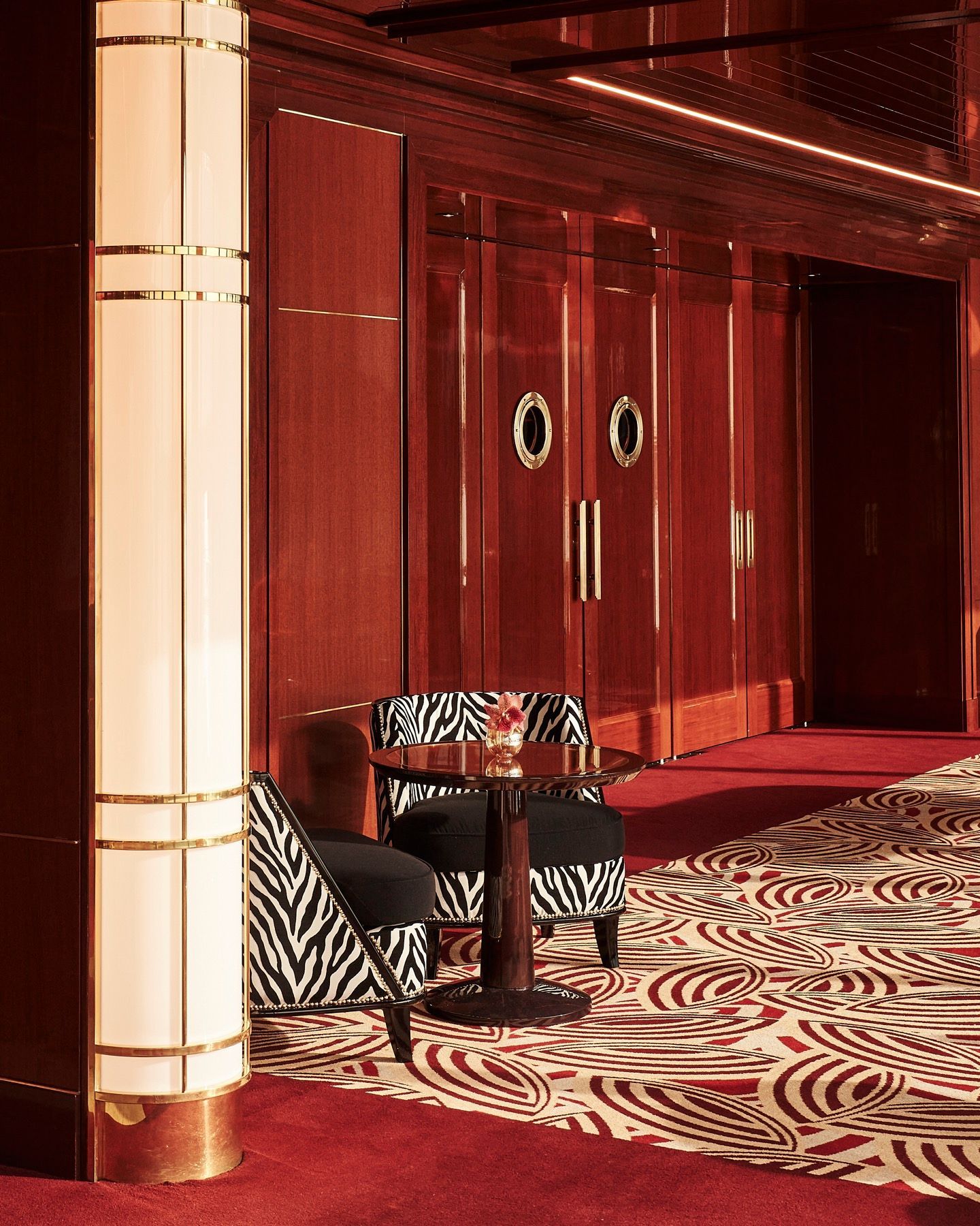 A hallway with zebra print chairs and a table