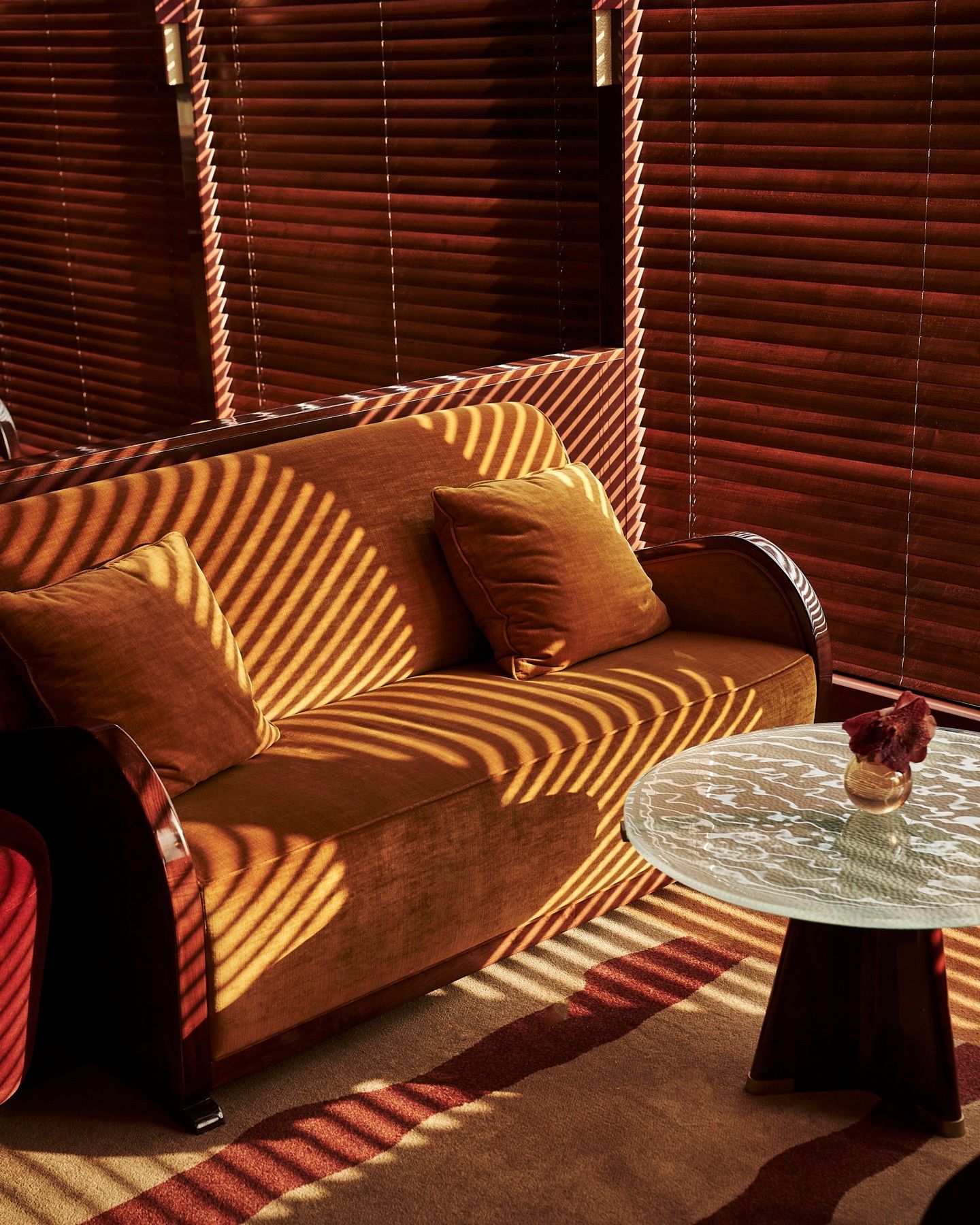 A living room with a couch and a glass table