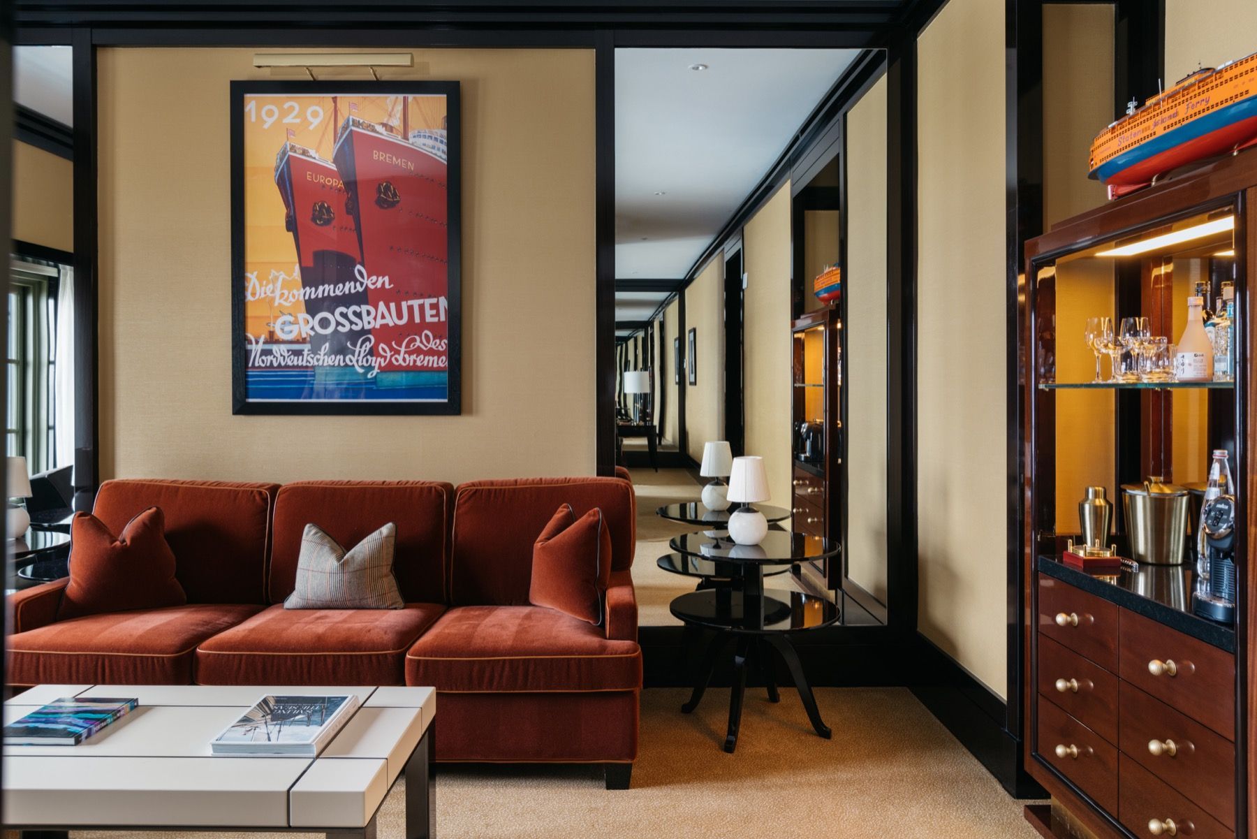 A living room with a couch , coffee table , and a picture on the wall.