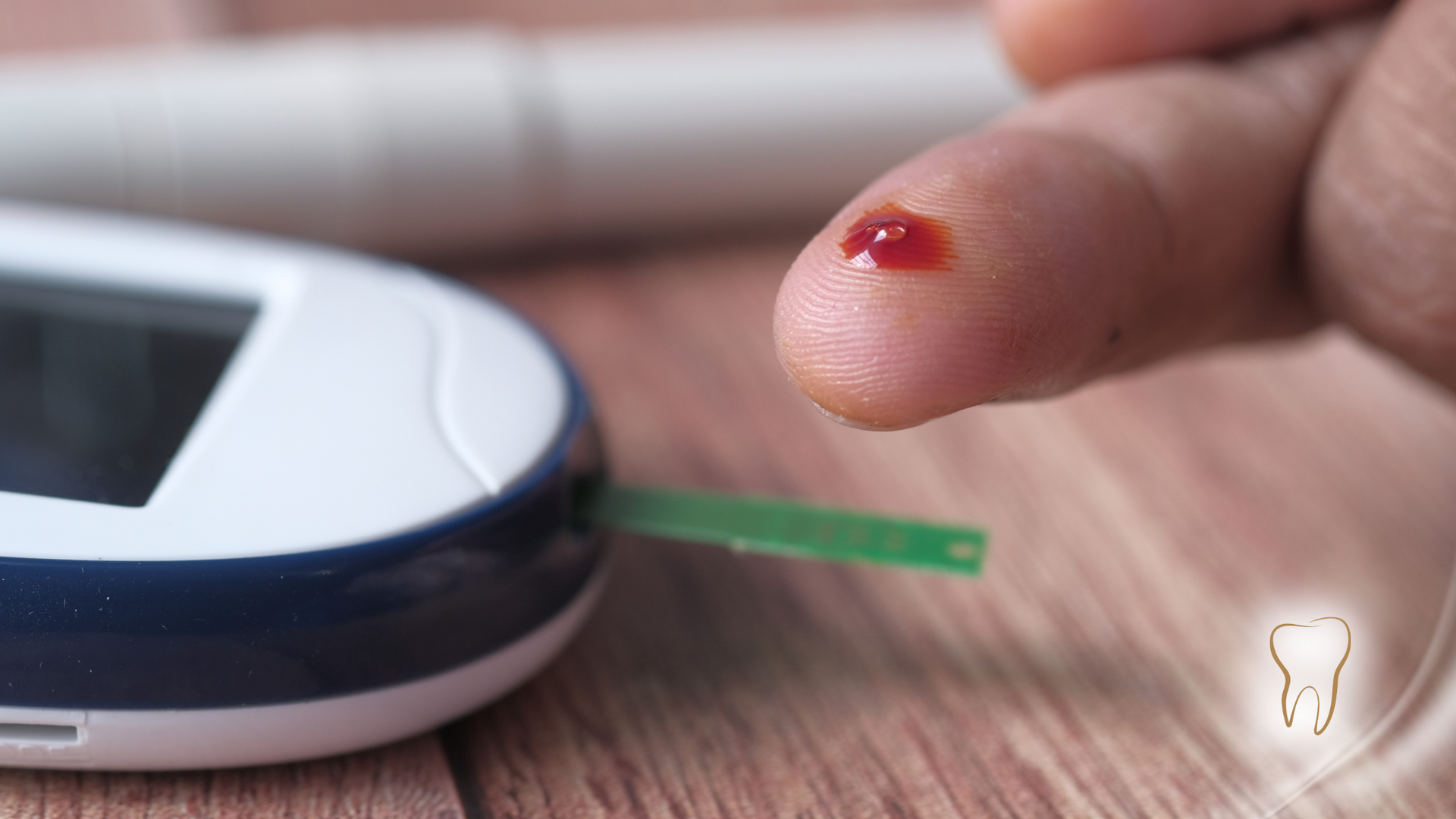 Finger with blood drop, testing blood sugar level with a glucometer.