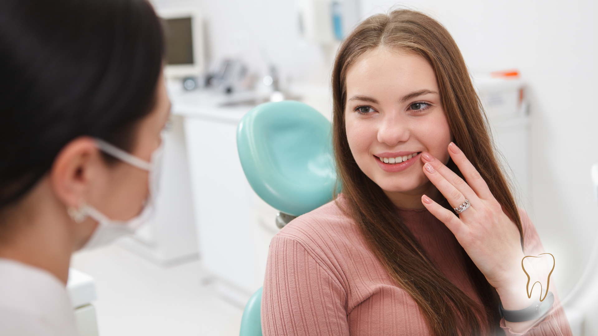A woman is sitting in a dental chair talking to a dentist.