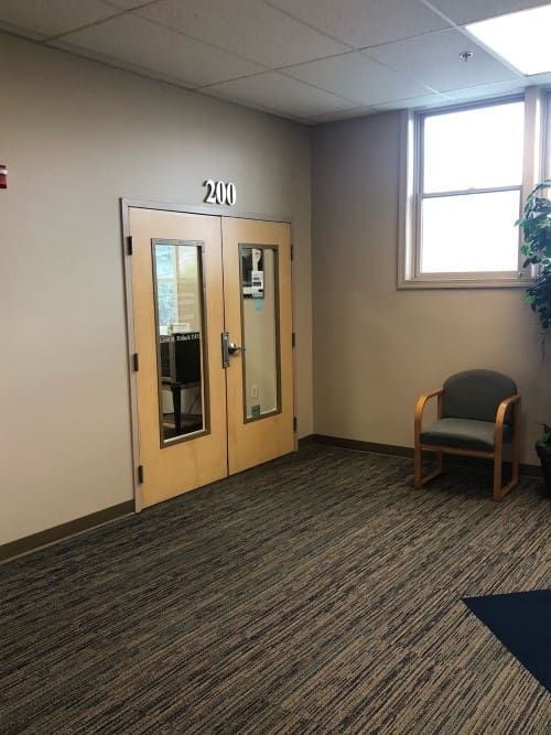 A room with two doors and a chair in it