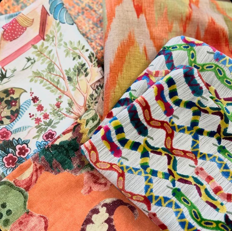 A bunch of colorful fabrics are laying on top of each other