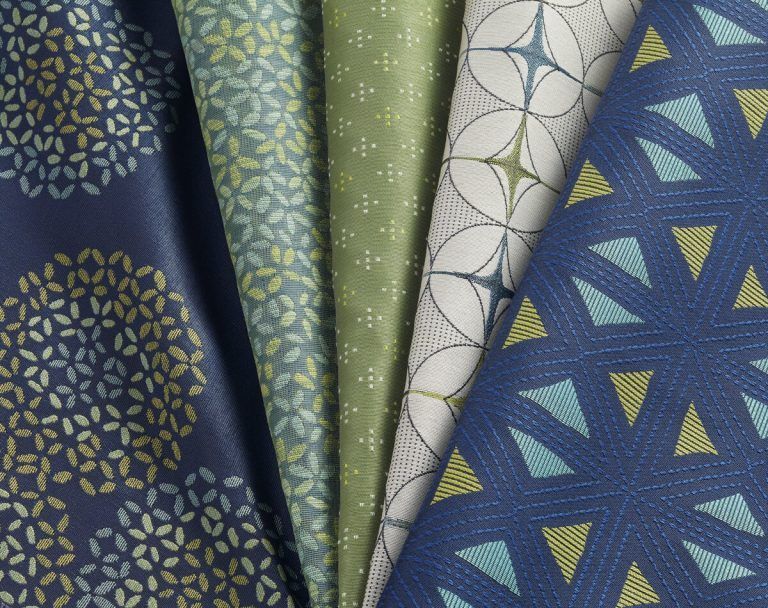 A stack of fabrics with different patterns on them
