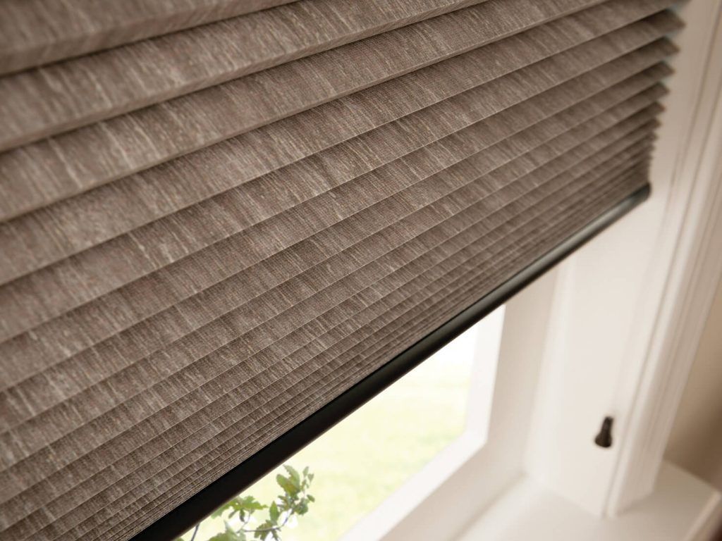 A close up of a window with a blind on it.