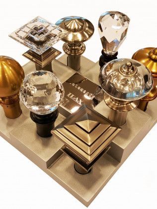 A bunch of different types of door knobs are on a table.
