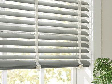 A close up of a window with blinds on it.