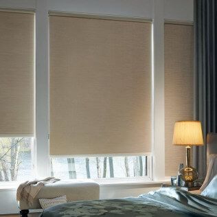 A bedroom with a bed , a lamp , and a window with blinds.
