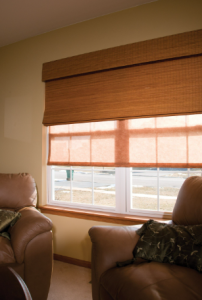 A living room with two chairs and a large window